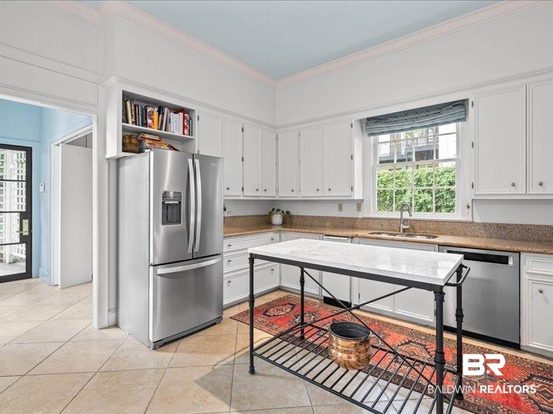 109 Eaton Square Mobile, AL 36608 - Photo 9 of 26 Kitchen featuring white cabinetry, stone countertops, a stainless steel refrigerator, and tiled flooring
