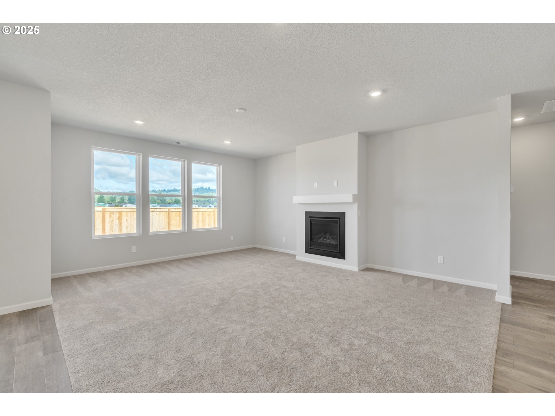 Undisclosed Address Albany, OR 97322 - Photo 28 of 42 a view of an empty room with a window and fireplace
