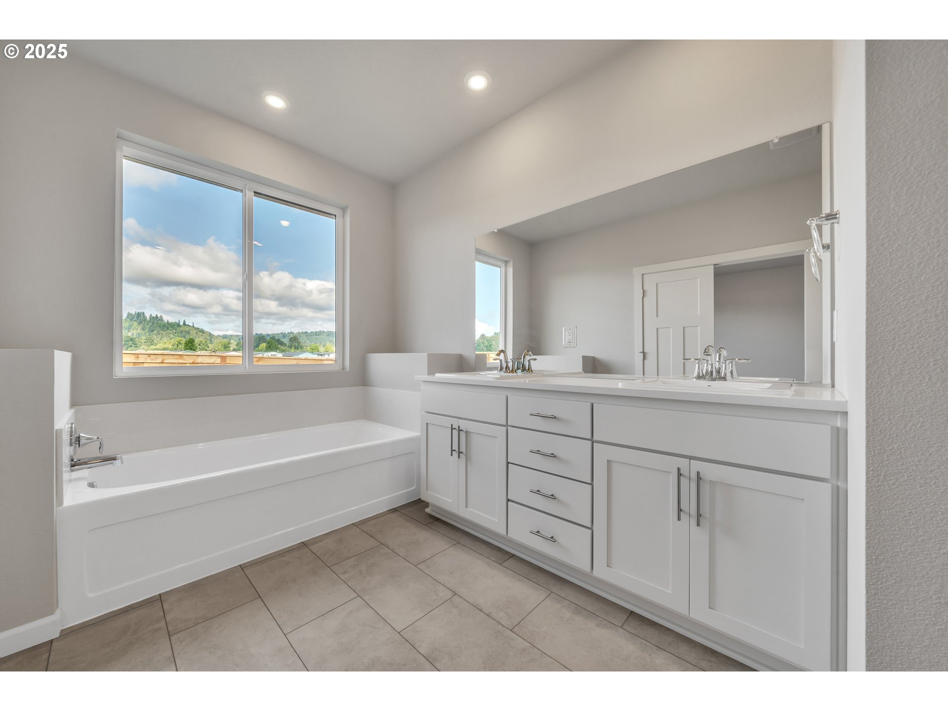 Undisclosed Address Albany, OR 97322 - Photo 35 of 42 a spacious bathroom with a double vanity sink a bathtub and a mirror