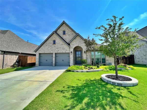 a front view of a house with a yard fire pit and trees