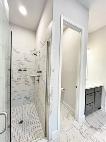 a bathroom with a tub and shower