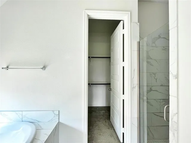 a spacious bathroom with a double vanity sink and a mirror