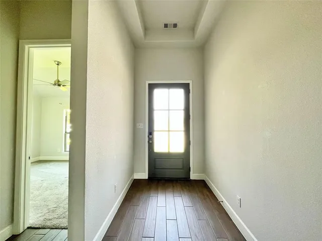 a large white kitchen with a large window