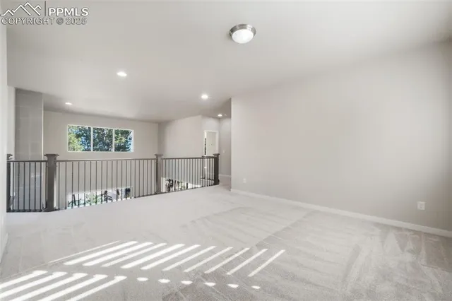 an empty room with windows and television