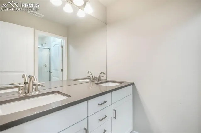 a view of a brick house with a yard and lawn chairs