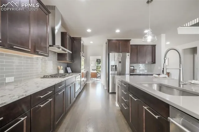 a kitchen with stainless steel appliances a stove sink microwave and cabinets