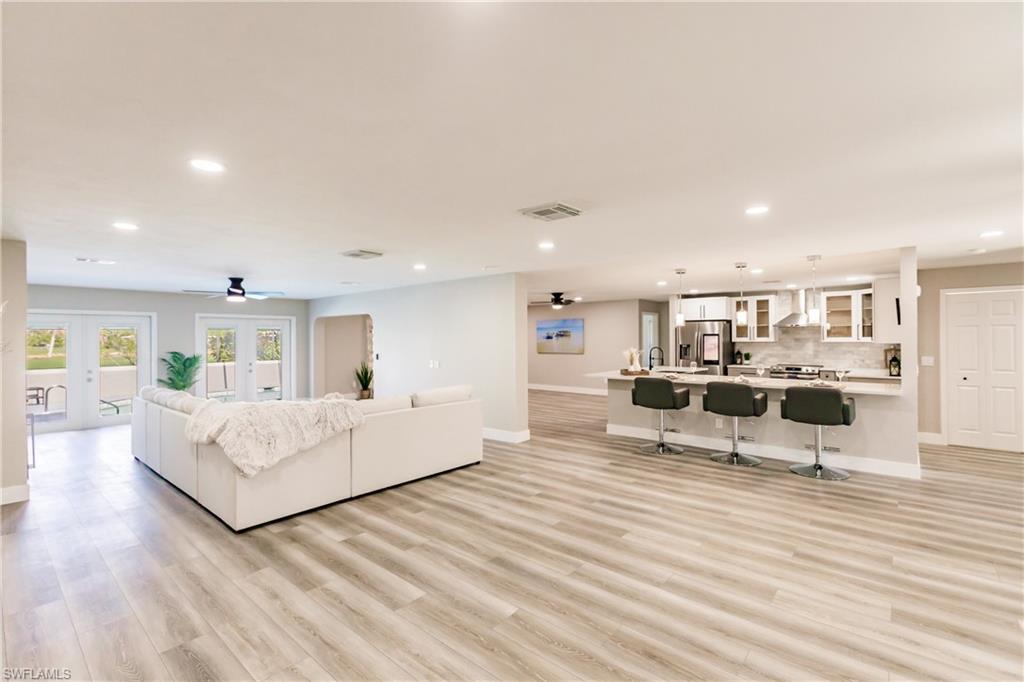 a living room with furniture and view of kitchen