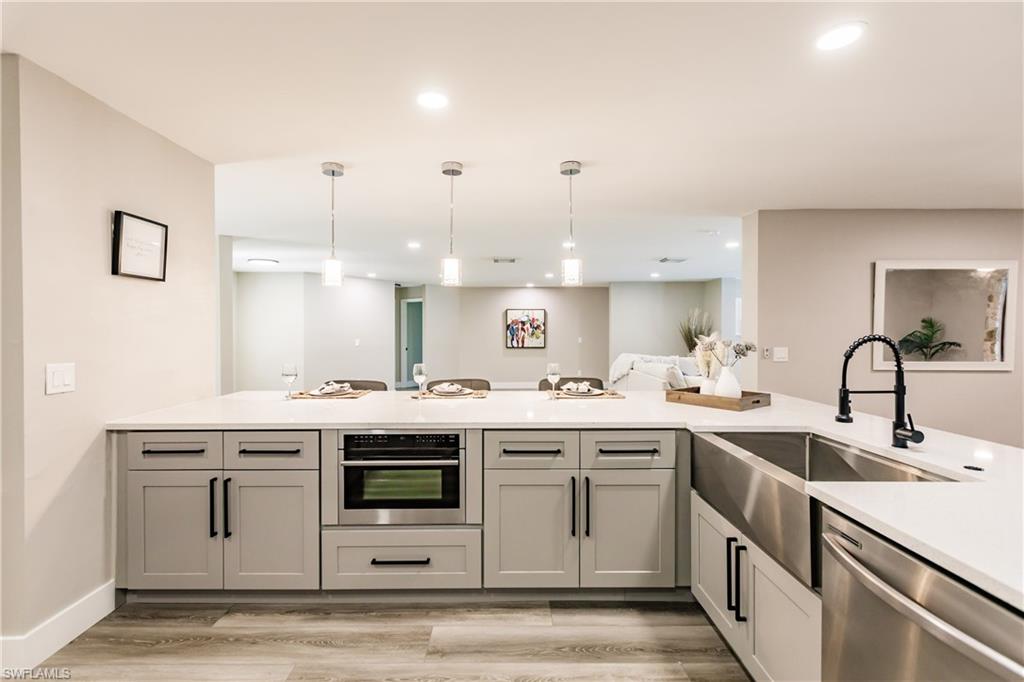 362 Pinehurst Circle Naples, FL 34113 - Photo 12 of 50 a kitchen with a sink stove and cabinets