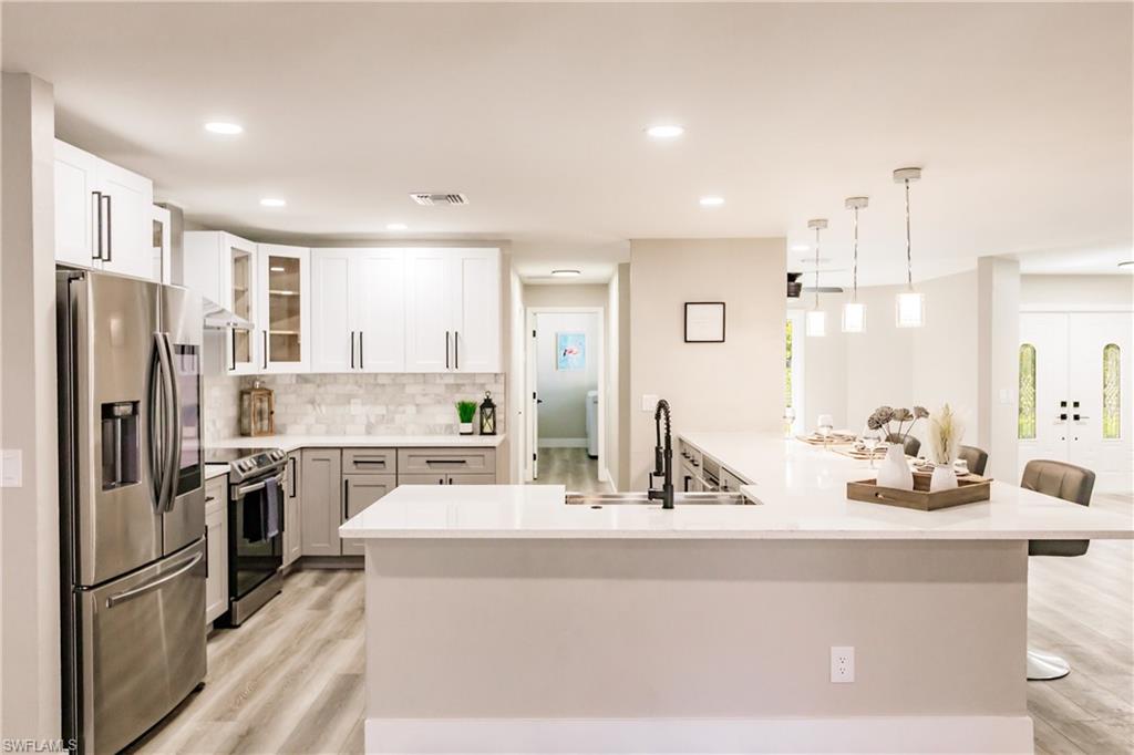 362 Pinehurst Circle Naples, FL 34113 - Photo 14 of 50 a kitchen with a refrigerator and a sink