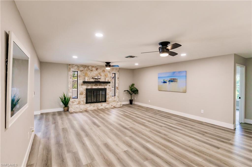 362 Pinehurst Circle Naples, FL 34113 - Photo 17 of 50 an empty room with windows and fireplace