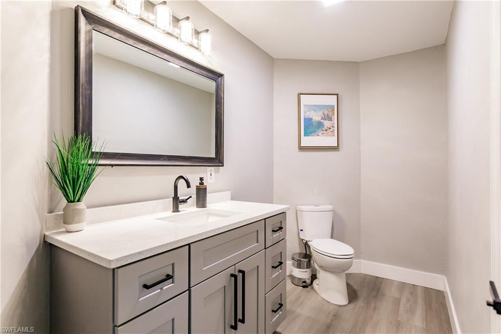 362 Pinehurst Circle Naples, FL 34113 - Photo 19 of 50 a bathroom with a sink vanity and a toilet