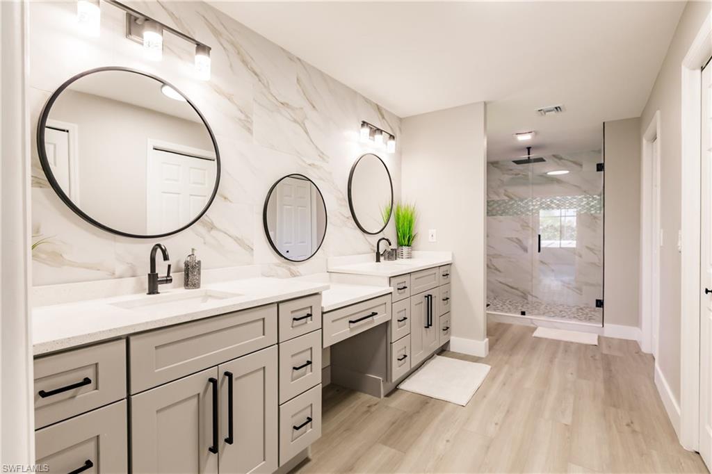 362 Pinehurst Circle Naples, FL 34113 - Photo 20 of 50 a bathroom with a granite countertop double vanity sink and a mirror