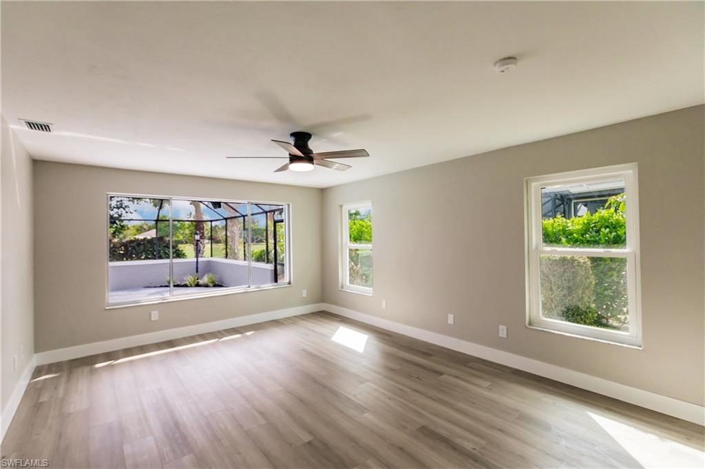 362 Pinehurst Circle Naples, FL 34113 - Photo 23 of 50 an empty room with wooden floor and windows