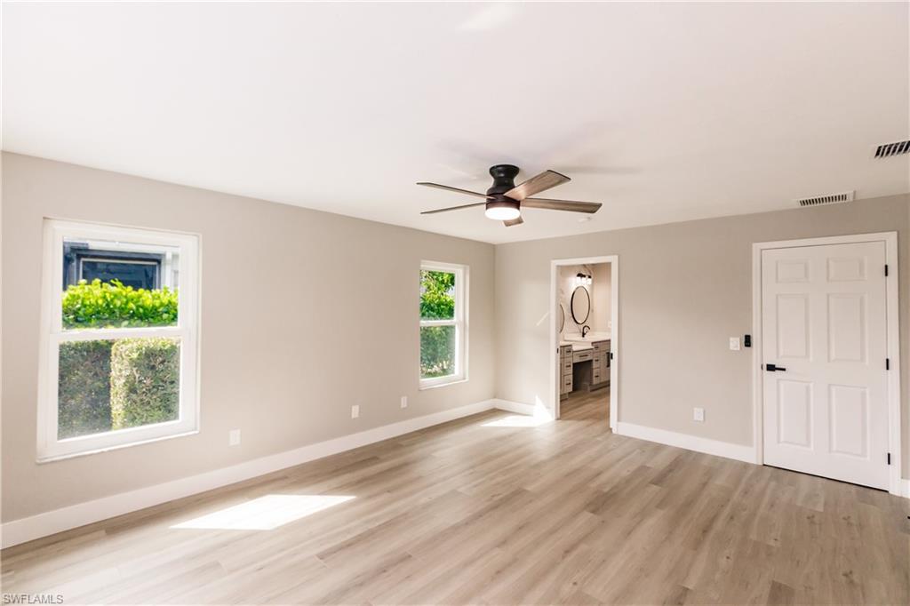 362 Pinehurst Circle Naples, FL 34113 - Photo 24 of 50 a view of empty room with wooden floor and fan