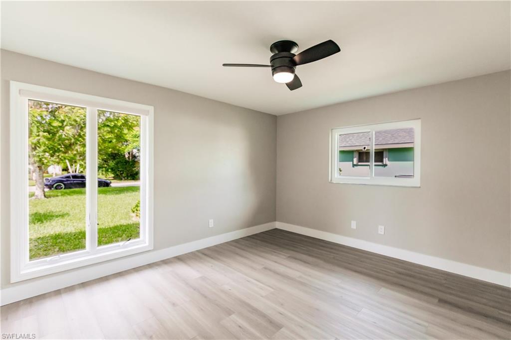 362 Pinehurst Circle Naples, FL 34113 - Photo 27 of 50 a view of empty room with wooden floor and fan