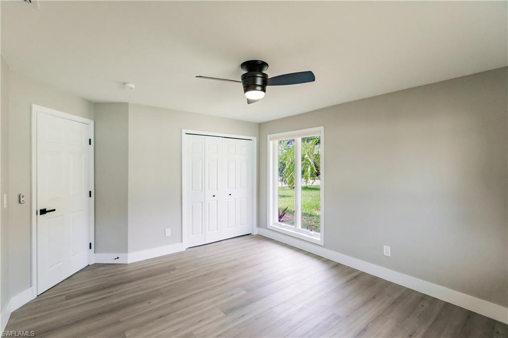 362 Pinehurst Circle Naples, FL 34113 - Photo 28 of 50 wooden floor in an empty room with a window