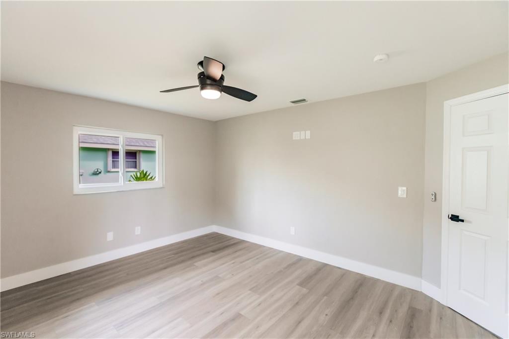 362 Pinehurst Circle Naples, FL 34113 - Photo 29 of 50 a view of a room with wooden floor and ceiling fan