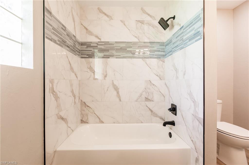 362 Pinehurst Circle Naples, FL 34113 - Photo 34 of 50 a bathroom with a bathtub and shower