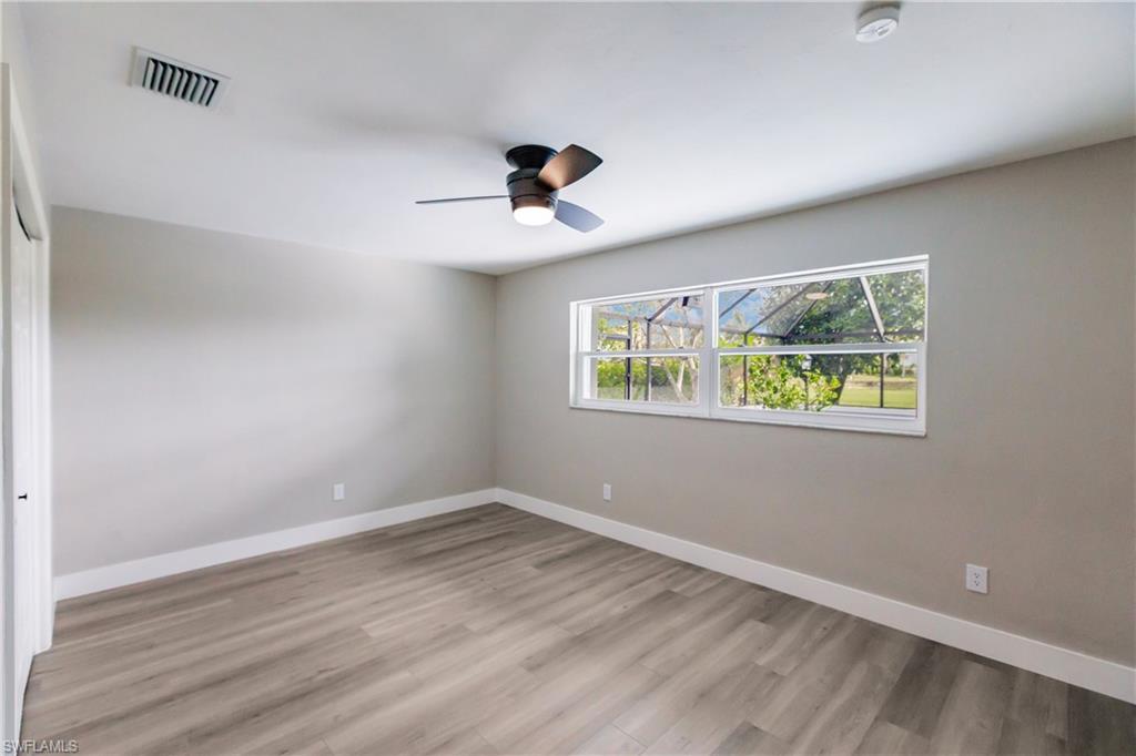 362 Pinehurst Circle Naples, FL 34113 - Photo 35 of 50 a view of an empty room with wooden floor and window