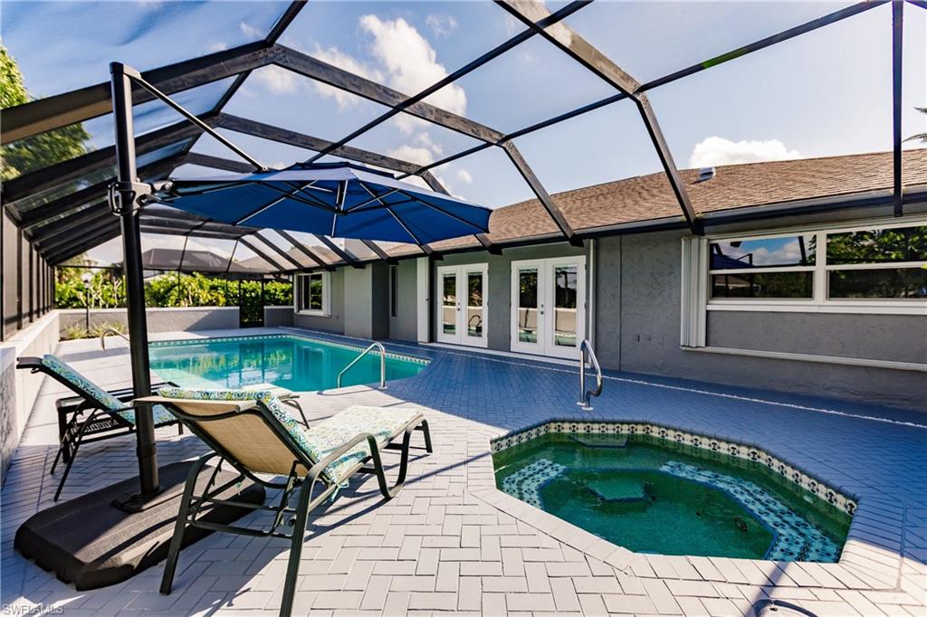 362 Pinehurst Circle Naples, FL 34113 - Photo 39 of 50 a backyard of a house with barbeque oven table and chairs