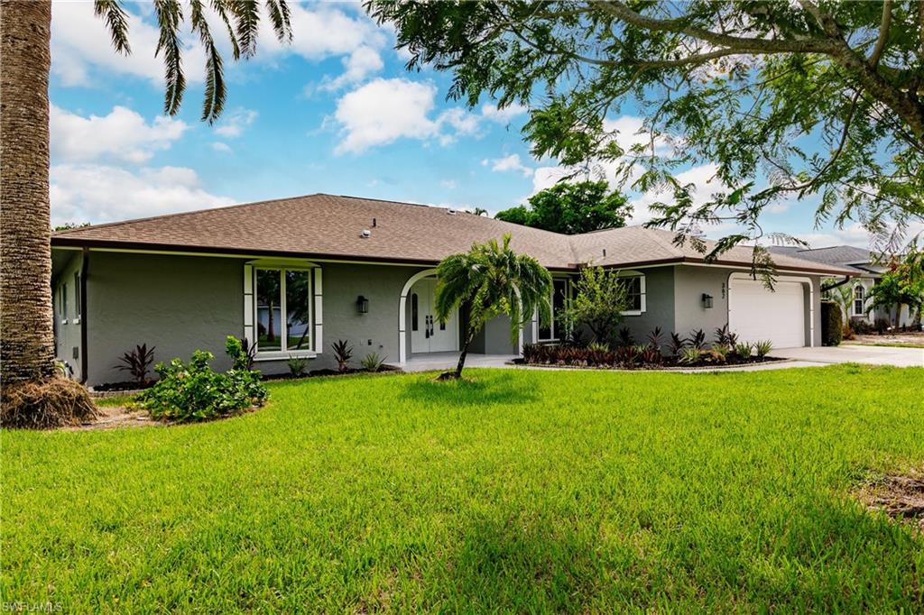 362 Pinehurst Circle Naples, FL 34113 - Photo 45 of 50 a front view of a house with a garden