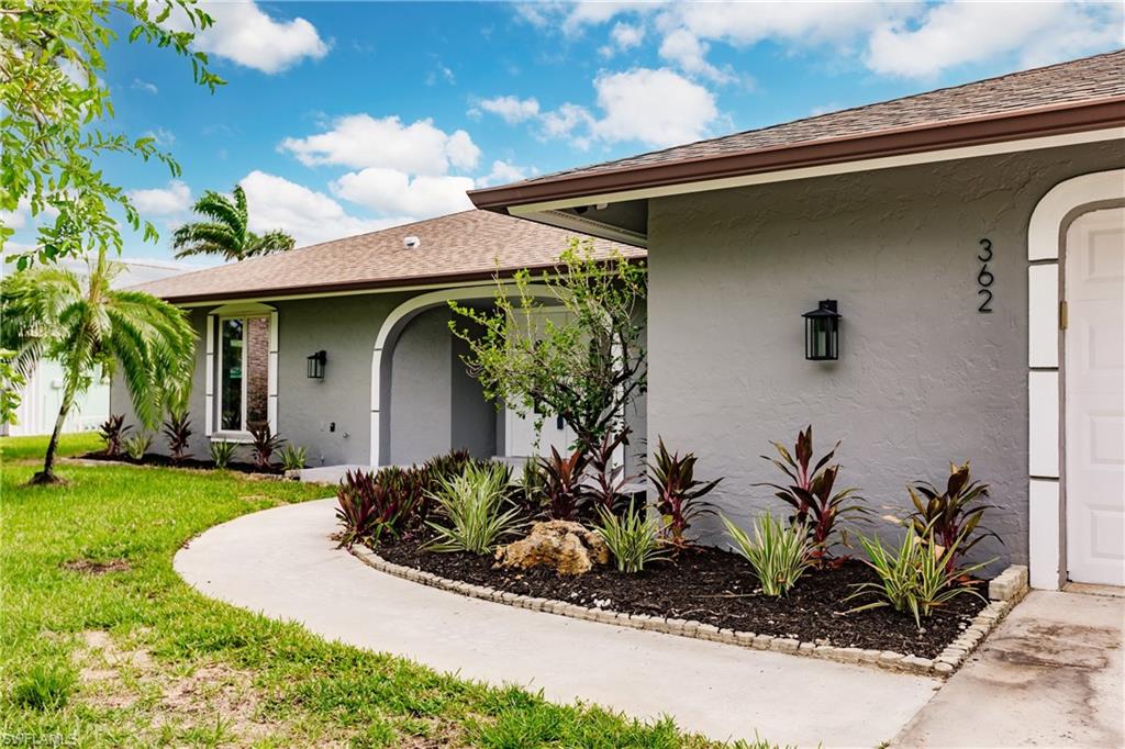 362 Pinehurst Circle Naples, FL 34113 - Photo 46 of 50 a front view of a house with a yard
