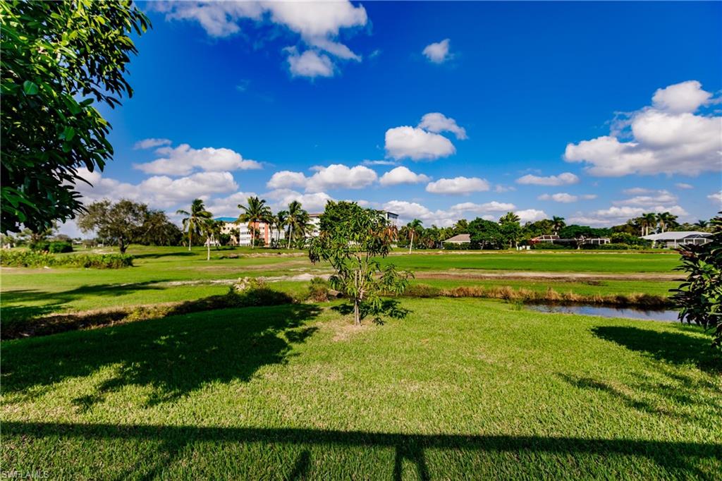 362 Pinehurst Circle Naples, FL 34113 - Photo 48 of 50 a view of a golf course with the lake