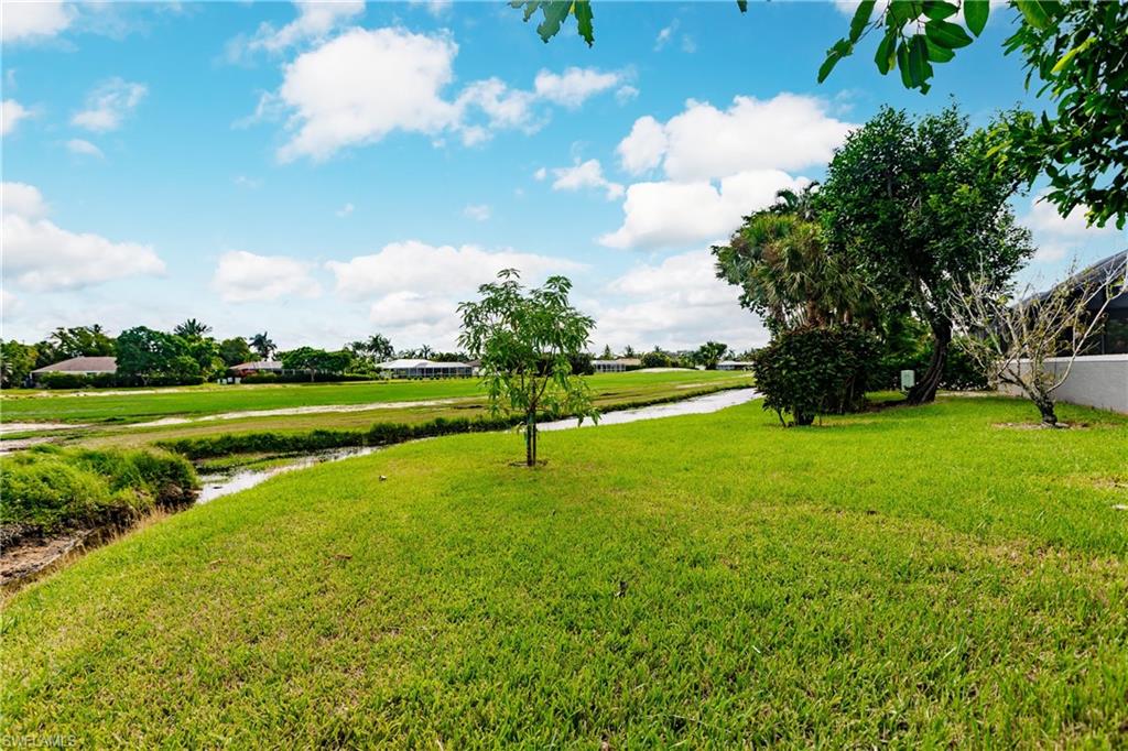 362 Pinehurst Circle Naples, FL 34113 - Photo 49 of 50 a view of a golf course with a lake