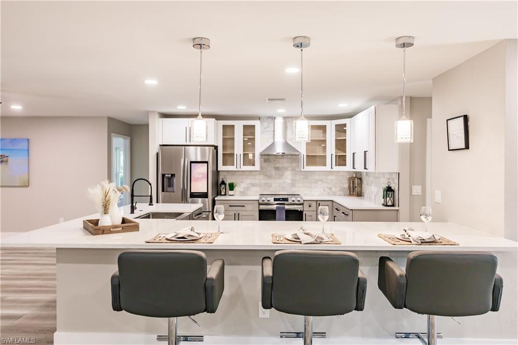 362 Pinehurst Circle Naples, FL 34113 - Photo 8 of 50 a kitchen with stainless steel appliances kitchen island granite countertop a sink and cabinets