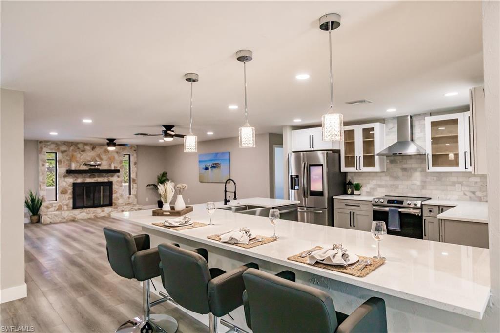 362 Pinehurst Circle Naples, FL 34113 - Photo 9 of 50 a kitchen with kitchen island granite countertop a sink counter top space appliances and cabinets