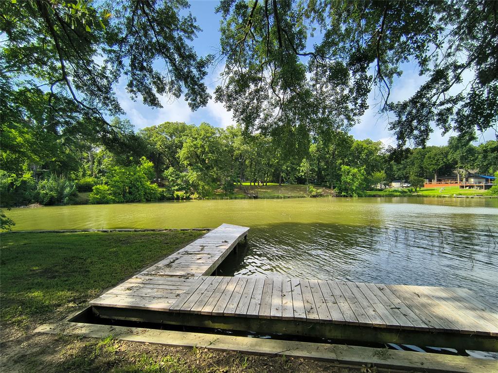 180 Arrowhead Street Mabank, TX 75156 - Photo 18 of 26 a view of a lake with a big yard