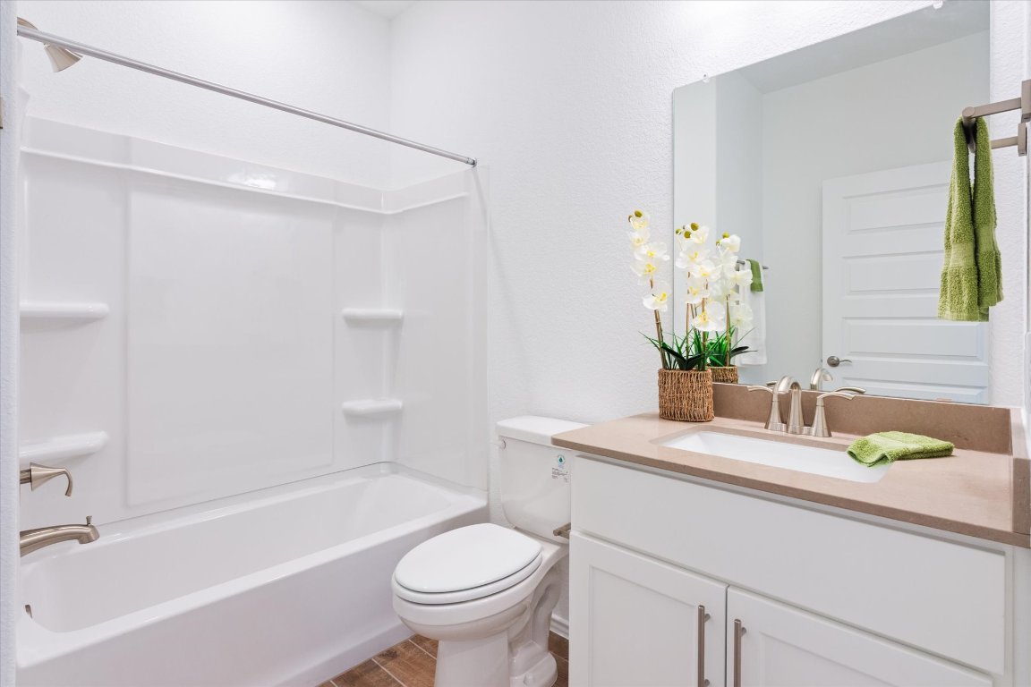 324 Livewater Lane Georgetown, TX 78633 - Photo 9 of 31 a bathroom with a sink and mirror with bathtub