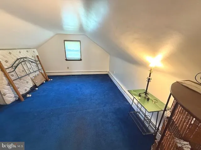 a view of an empty room with wooden floor and windows