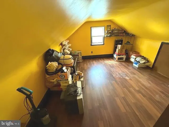 a view of a workspace room with wooden floor and windows