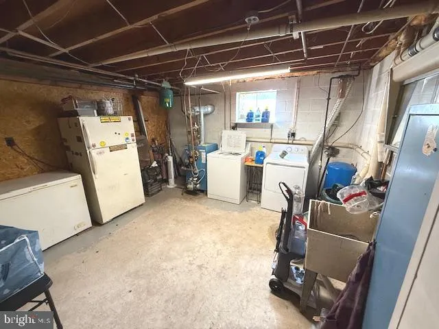 a view of storage and utility room with washer and dryer