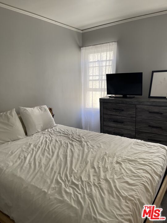 200 South Reeves Drive, Unit 7 Beverly Hills, CA 90212 - Photo 8 of 10 a bedroom with a bed and flat screen tv
