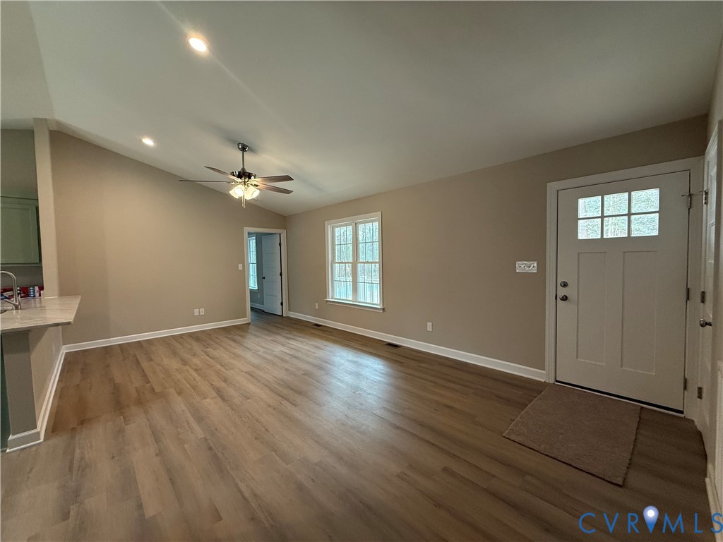 342 Barefords Mill Road Dunnsville, VA 22454 - Photo 15 of 15 an empty room with wooden floor and windows