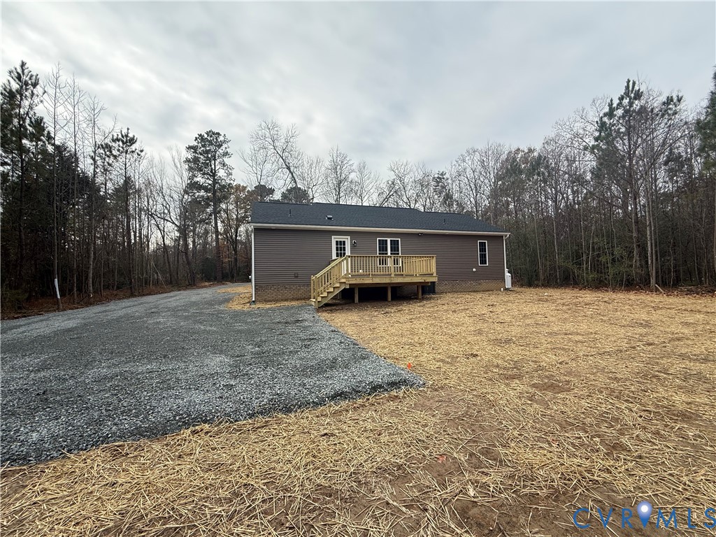 342 Barefords Mill Road Dunnsville, VA 22454 - Photo 2 of 15 a front view of a house with a yard and trees