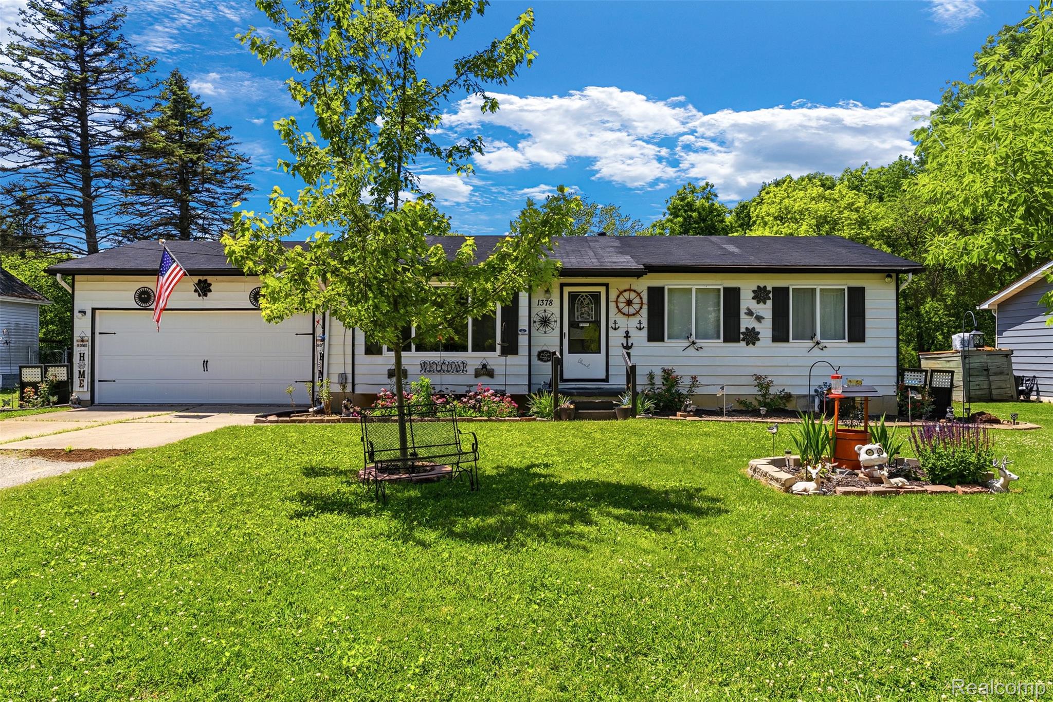 1378 Roat Court Burton, MI 48509 - Photo 2 of 30 Ranch-style residence featuring white siding, a dark roof, and a single-car garage