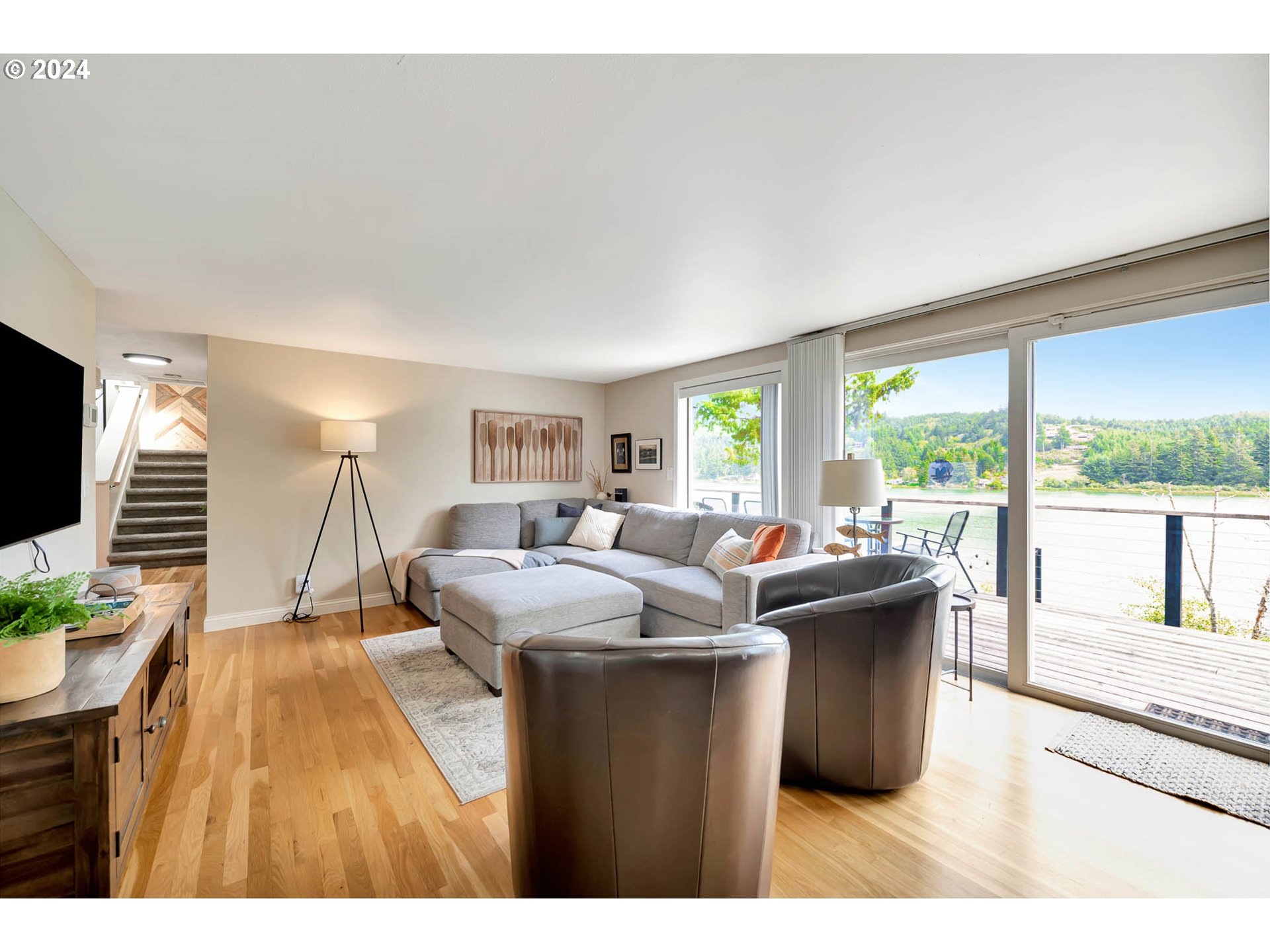 5378 Buckskin Bob Road Florence, OR 97439 - Photo 11 of 46 a living room with a large window and a wooden floor