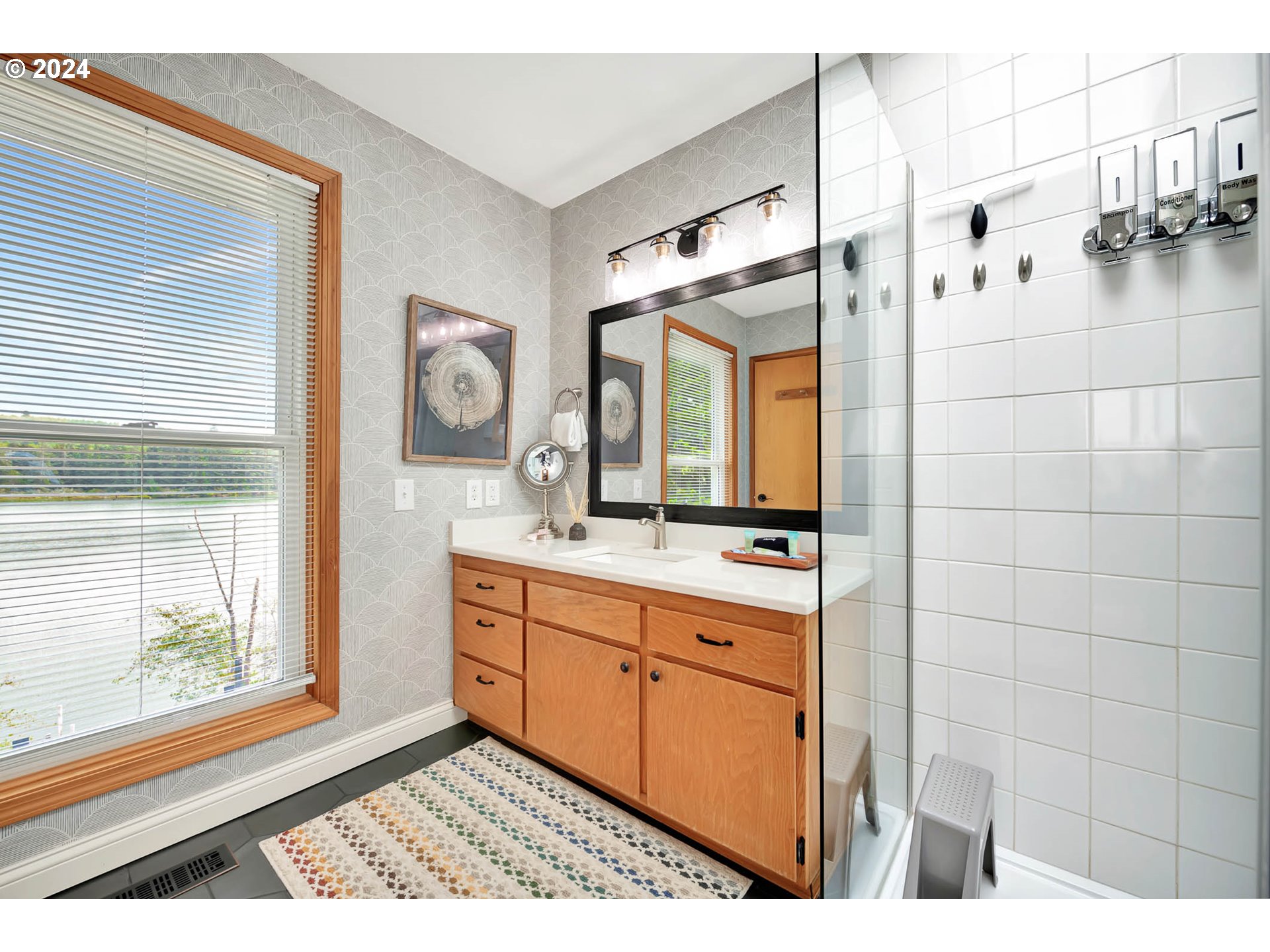 5378 Buckskin Bob Road Florence, OR 97439 - Photo 19 of 46 a bathroom with a sink a mirror and a shower