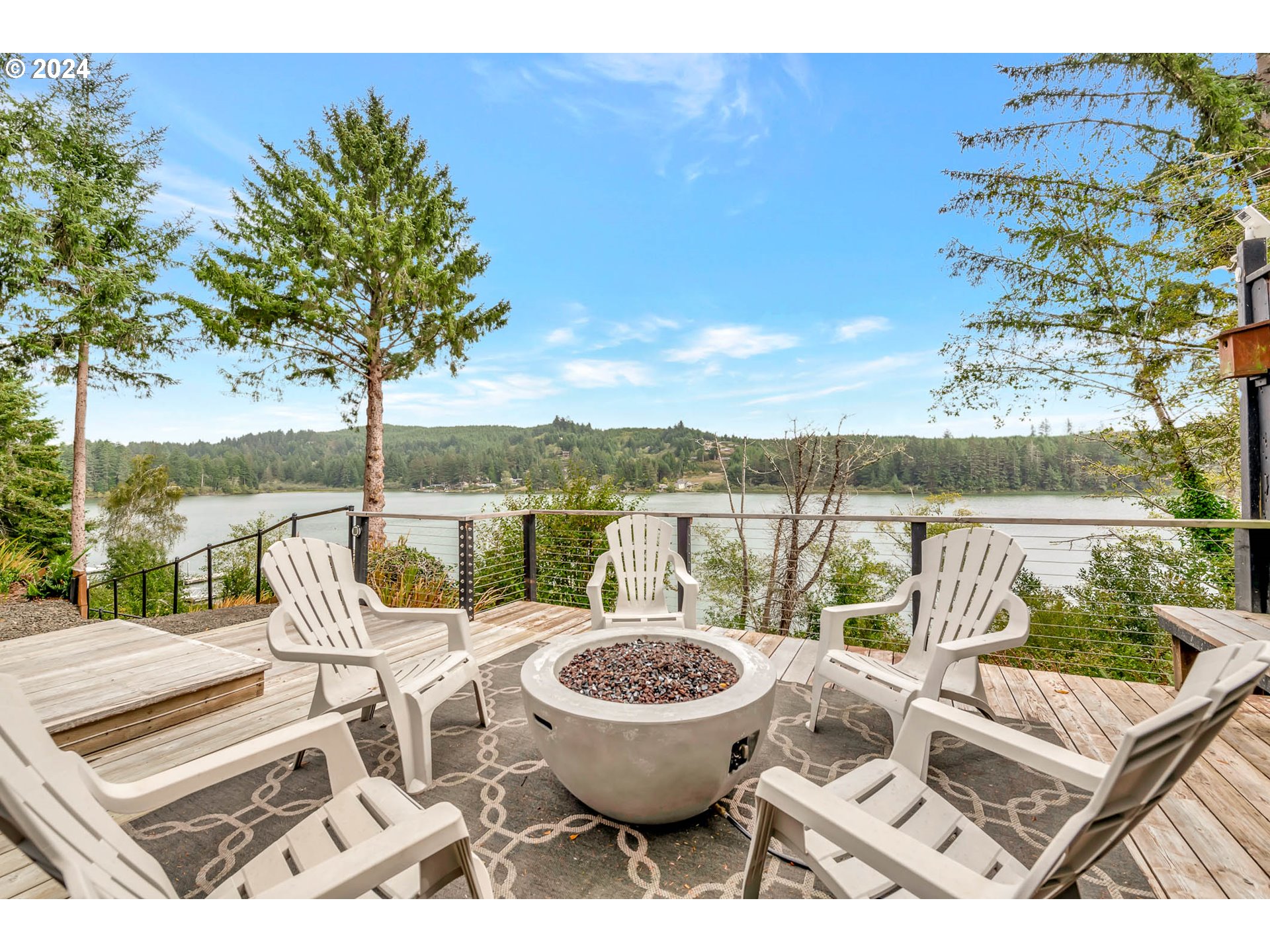 5378 Buckskin Bob Road Florence, OR 97439 - Photo 35 of 46 a view of a chairs and table in patio with a lake view