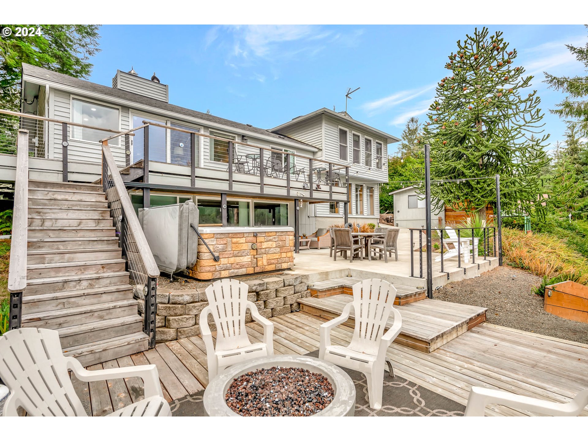5378 Buckskin Bob Road Florence, OR 97439 - Photo 4 of 46 a view of a patio with couches table and chairs and potted plants