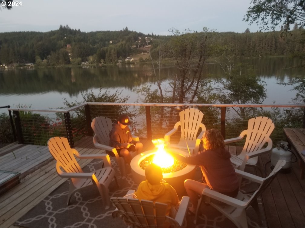 5378 Buckskin Bob Road Florence, OR 97439 - Photo 45 of 46 a view of a lake with couches and wooden floor