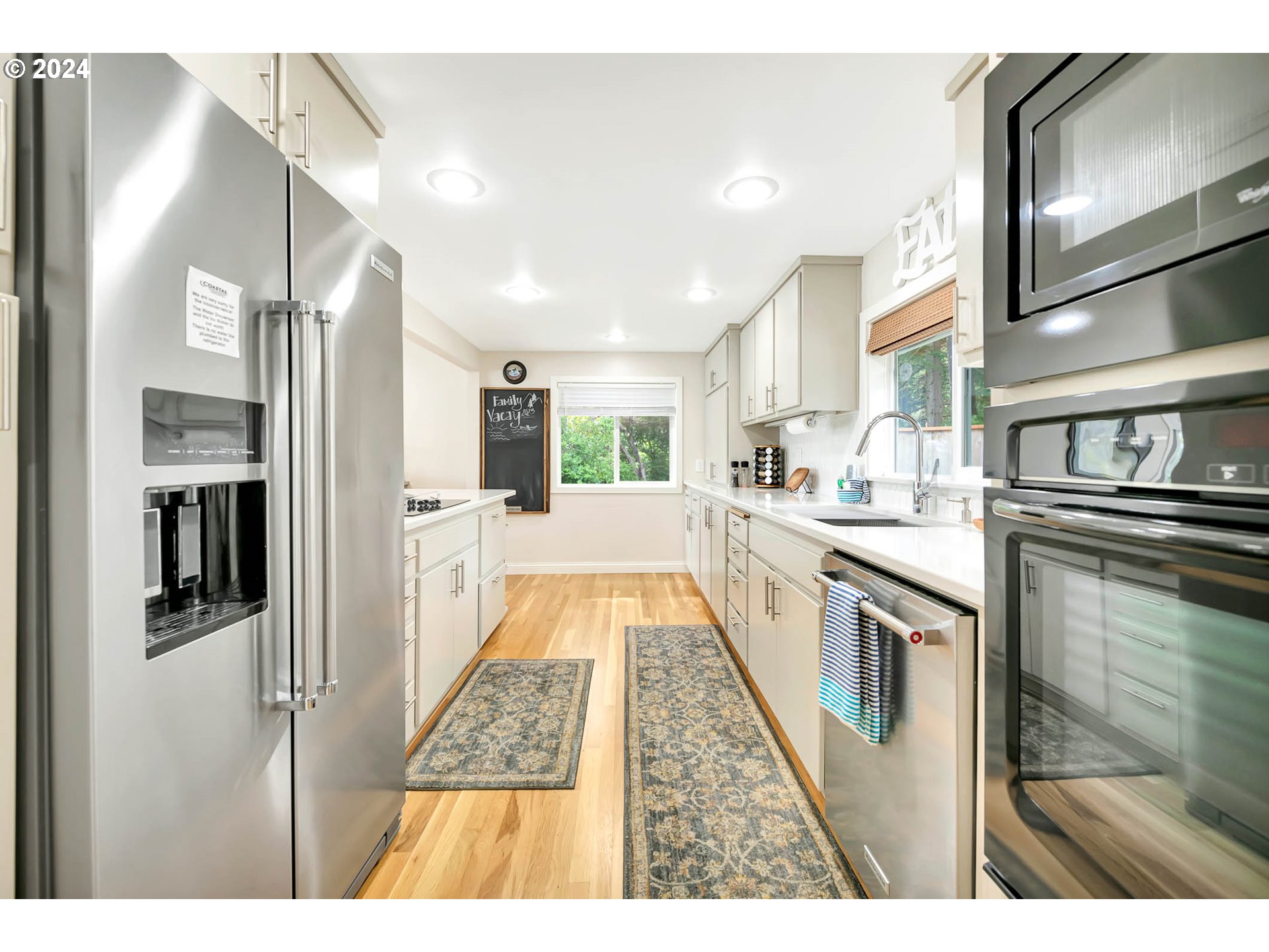 5378 Buckskin Bob Road Florence, OR 97439 - Photo 5 of 46 a open kitchen with stainless steel appliances kitchen island granite countertop a refrigerator and a sink