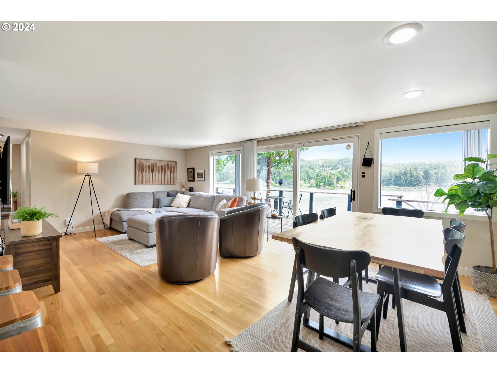 5378 Buckskin Bob Road Florence, OR 97439 - Photo 9 of 46 a dining room with a table chairs and a kitchen view