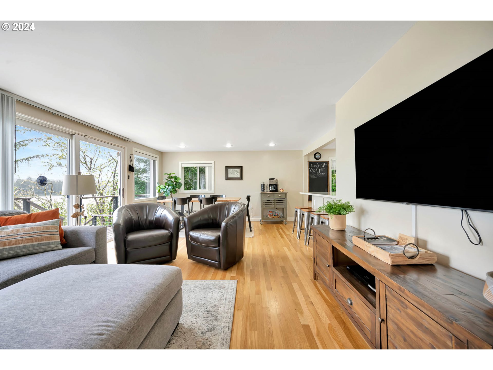 5378 Buckskin Bob Road Florence, OR 97439 - Photo 10 of 46 a living room with furniture a flat screen tv and a large window