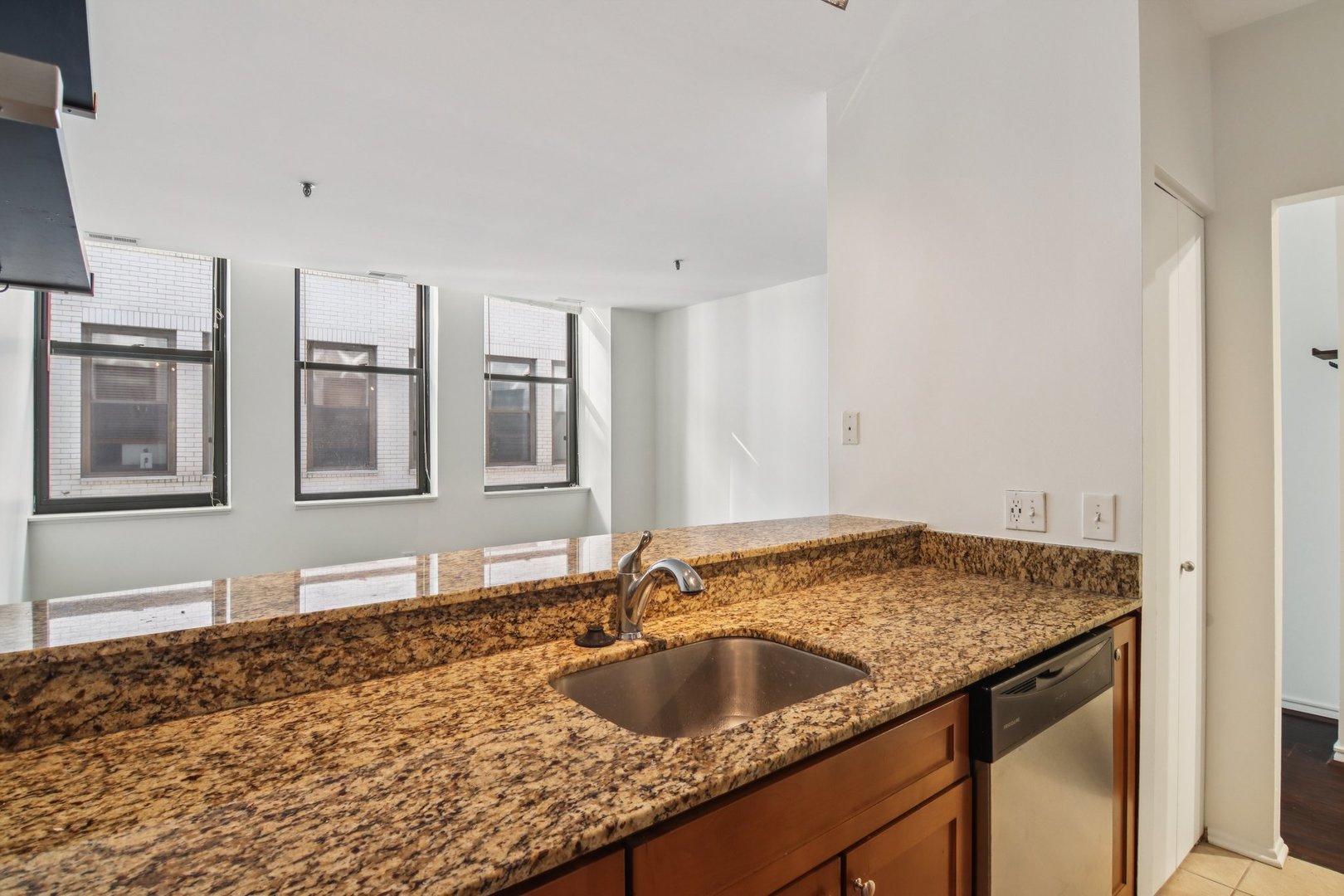780 South Federal Street, Unit 902 Chicago, IL 60605 - Photo 15 of 28 a bathroom with a granite countertop sink and two natural light