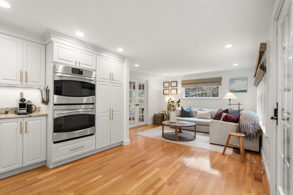 9 Lafayette Circle Wellesley, MA 02482 - Photo 16 of 35 a living room with furniture a flat screen tv and kitchen view
