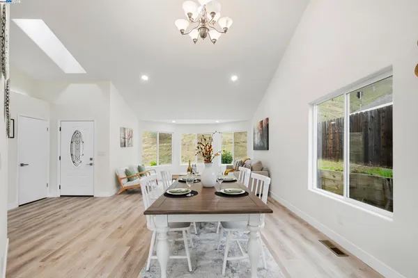 a living room with furniture a fireplace and a table